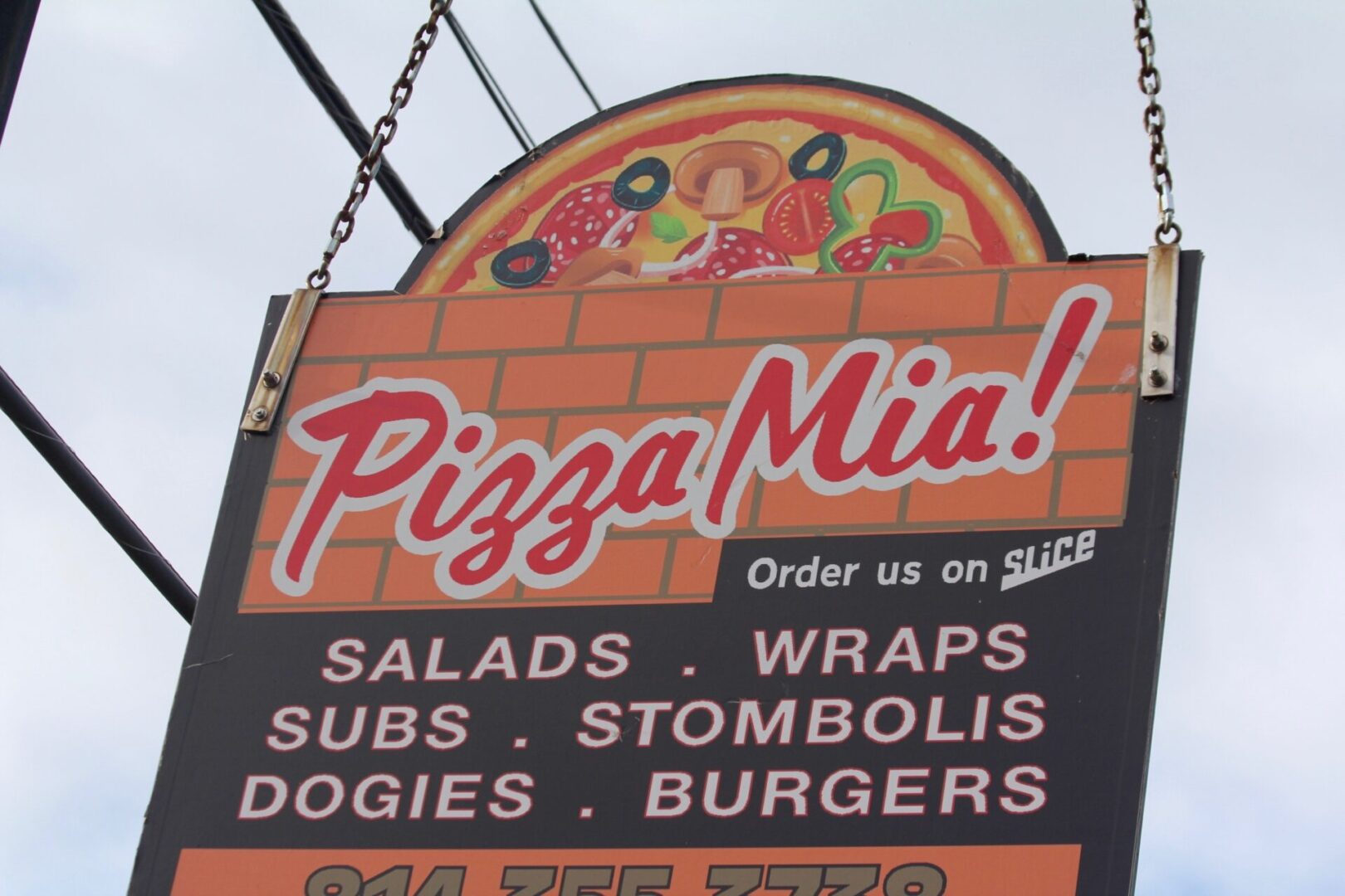 Pizza Mia! sign hanging outside the restaurant in Bellefonte