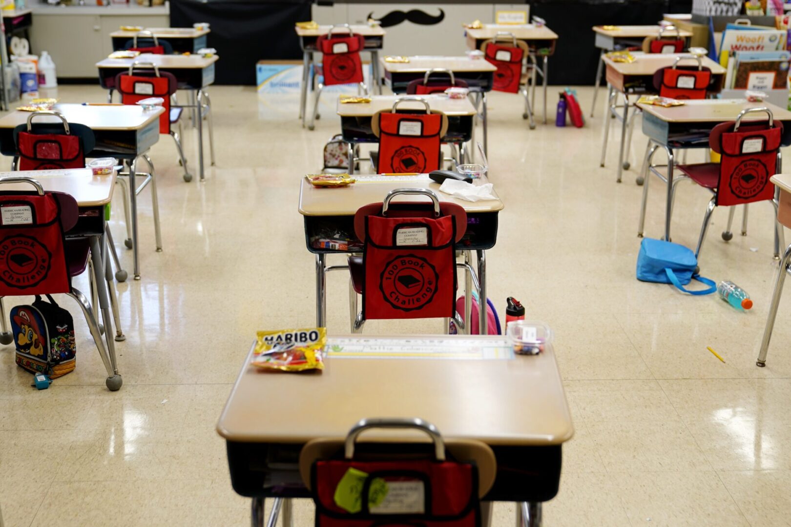 FILE - Desks are arranged in a classroom at an elementary school in Nesquehoning, Pa., March 11, 2021. The COVID-19 pandemic that shuttered classrooms set back learning in some U.S. school systems by more than a year, with children in high-poverty areas affected the most, according to a district-by-district analysis of test scores shared exclusively with The Associated Press. (AP Photo/Matt Slocum, File)