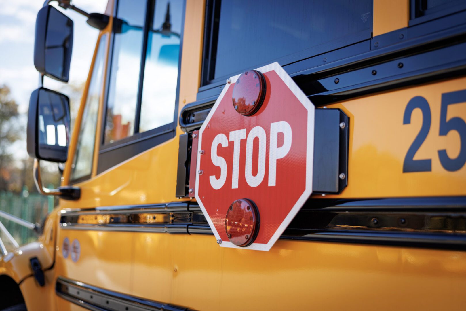 red stop sign on a yellow school bus