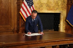 Gov. Josh Shapiro signs an executive order regarding standards for data centers on Aug. 18, 2026, in Harrisburg, PA.